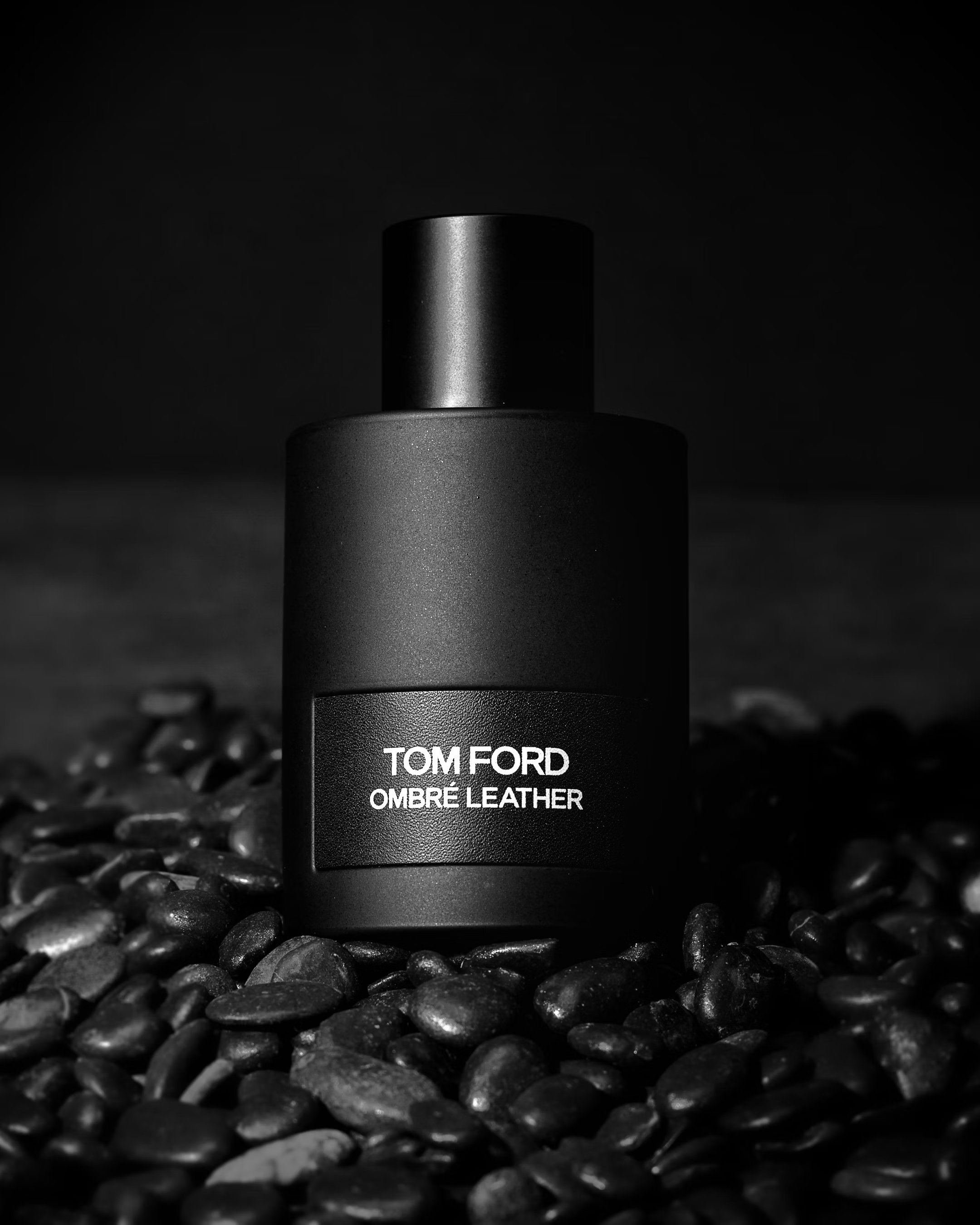 Tom Ford Ombré Leather perfume bottle on black stones
